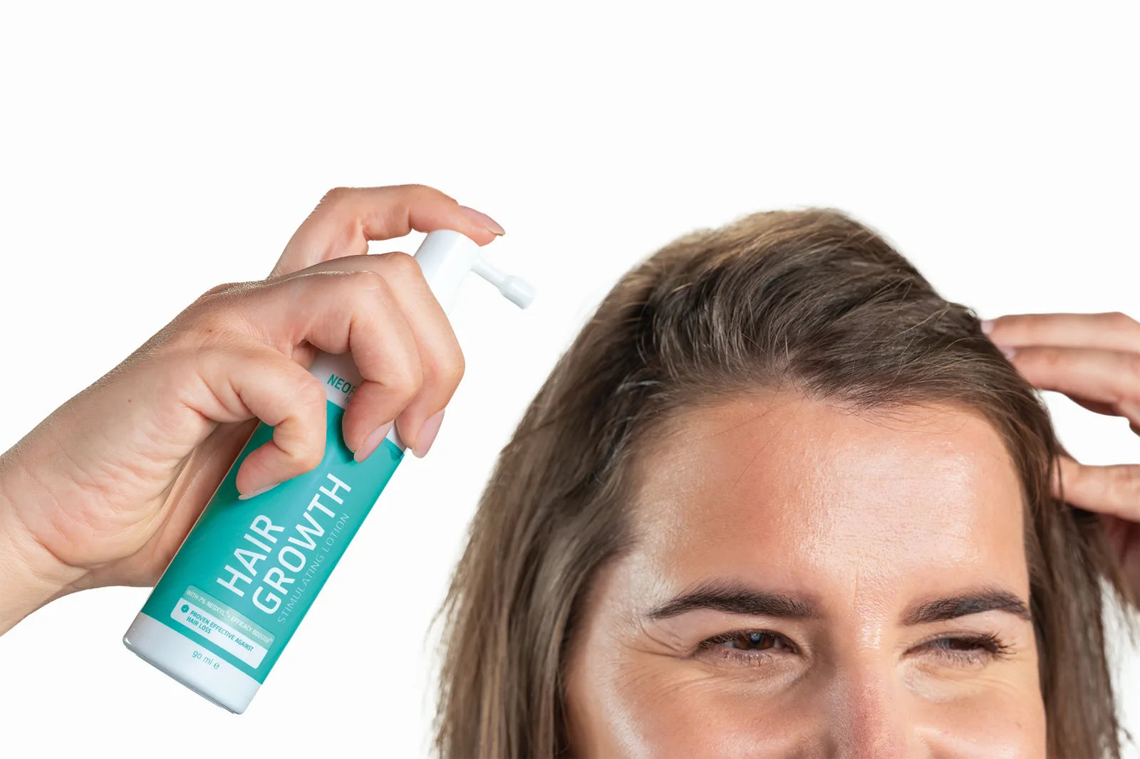 Applying Neofollics Hair Growth Stimulating Lotion to the parting
