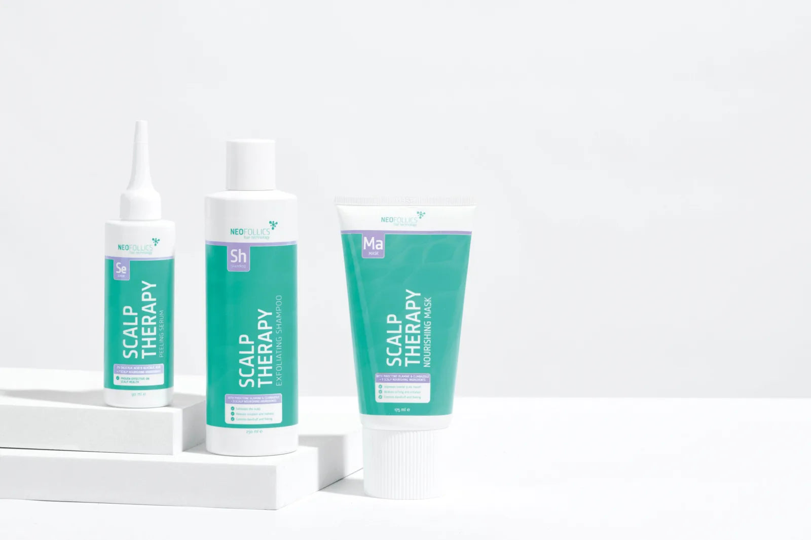 Neofollics Scalp Therapy Routine: peeling serum, exfoliating shampoo and nourishing mask on a white studio set